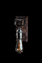 Vintage wall lamp to illuminate the terrace. Antique lamp with Edison bulb. The concept of saving...