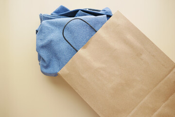 top view of craft paper bag with shirt ,