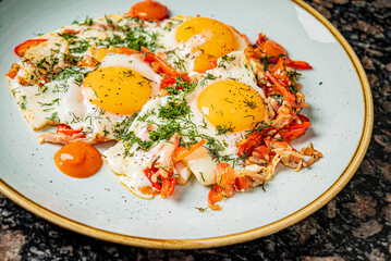 fried eggs with vegetables on the table