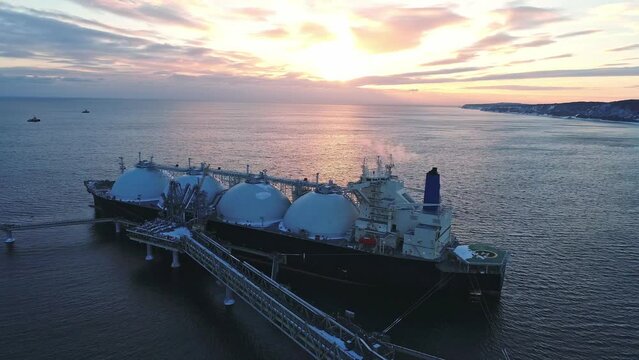 Aerial of Liquified Natural Gas LNG carrier moored to a small gas terminal. Fuel crisis. Sanctions