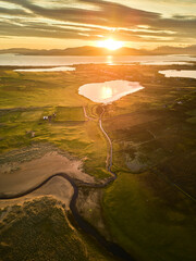 Irelands West on Achill Island. Drone shot of a lake and the coast at sunset