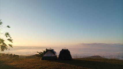 Fototapeta na wymiar Two camp on the mountain see view sea of mist and sunsine in the morning.