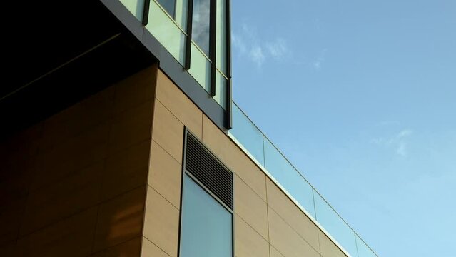 Modern Building Exterior With Wall Cladding Panels. low angle, tilt-down shot