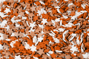 Color of the year 2024: Peach Fuzz. colorful star shape sprinkes decorations for fourth july texture