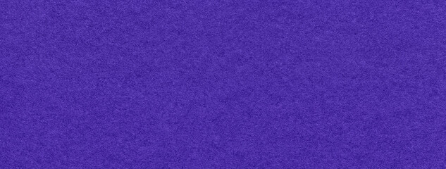 Texture of navy blue and violet colors paper background, macro. Structure of dense craft indigo...
