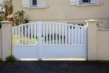 white door aluminum gate steel slats portal entrance home entry suburb house access