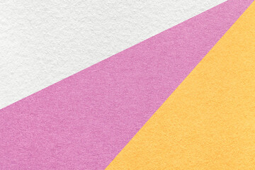 Texture of old craft white, pink and yellow color paper background, macro. Vintage abstract purple cardboard