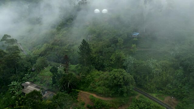 Establishing Aerial Drone Shot of Hills and Train Track in Ella on Misty Morning in Sri Lanka