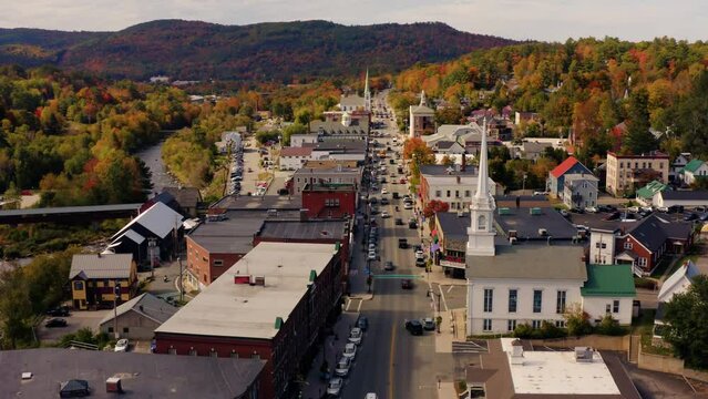 Drone panning parallax shot picturesque city center of New England during autumn fall.