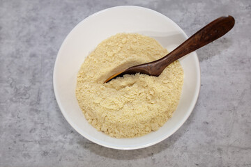 Fine almond flour in a white bowl.