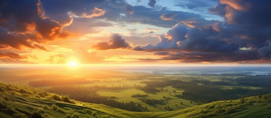 A stunning aerial perspective shows the sun setting in a vibrant sky above a peaceful countryside.