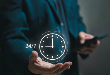 Concept of 24x7 hour MA. Businessman holding a watch icon in his hand. standard service, non-stop...