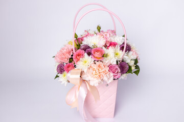 Beautiful bouquet of flowers in pink box on a white background. Gift for holiday, birthday,...