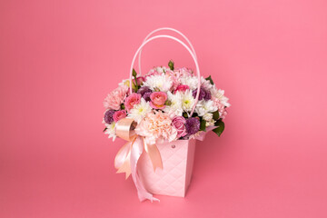 Beautiful bouquet of flowers on a pink background. Gift for holiday, birthday, Wedding, Mother's Day, Valentine's day, Women's Day. Floral arrangement in a hat box