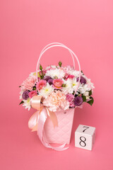 Number 8 with fresh spring flowers on bright pink background. Minimal Women's day, March 8th or birthday concept