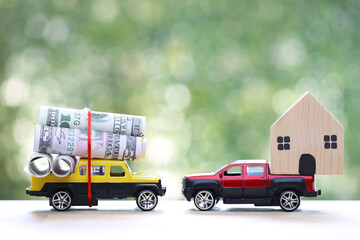 Real estate,Model house and usd dollar money on miniature car on nature green background, Saving money for car, Finance and car loan, Investment and business concept
