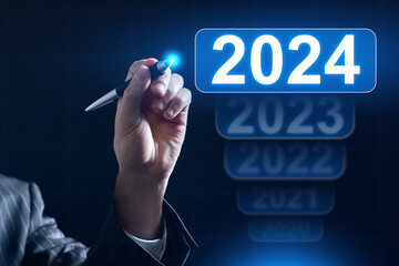 2024 businessman hand with stylus. 2024 button on virtual screen. Start of new year. Concept plan for 2024 for business. New season for commercial activity. Countdown to new year eve