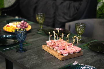 The focus on a charcuterie arrangement invites thoughts of culinary craftsmanship and the pleasures...