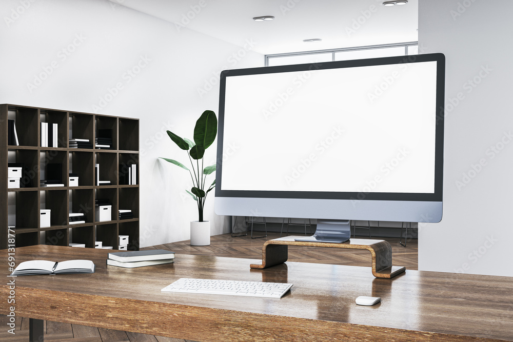 Poster Close up of wooden desk with blank white computer monitor, daylight and bookshelf in the background. Mock up, 3D Rendering.