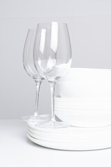 Clean dishes after washing in a dishwasher on a white background