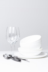 Clean dishes after washing in a dishwasher on a white background