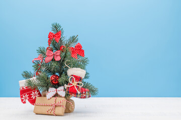 Cozy winter charm: Small decorated snowy Christmas tree