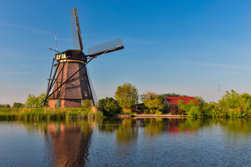Fototapeta premium Traditional Romantic Dutch Windmills in Kinderdijk Village in the Netherlands With Water Canal.