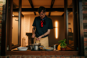 A male chef making an Italian food, ready to serve to his friends