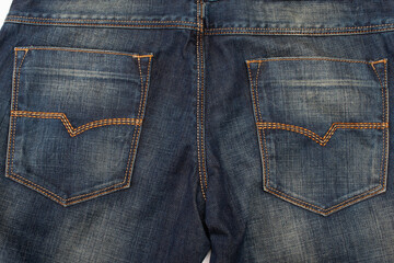 Fototapeta premium Closeup of Back Side of Pair of Dark Blue Washed Mens Jeans On Pure White