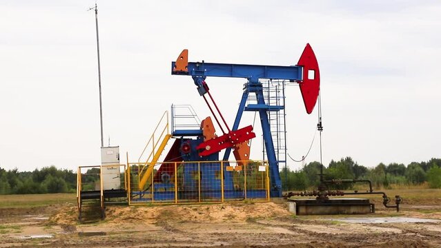 An oil pumping machine pumps oil out of a well in an oil field. Oil and gas equipment.