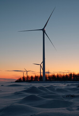 Renewable wind power generation on a wind farm on a cold winter morning in Northern Finland