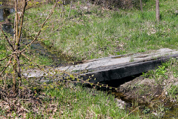 Bridge over a stream with a meadow in the background. Small Bridge over a Stream in the fild