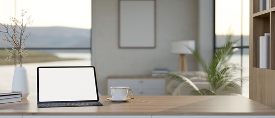 A white-screen digital tablet mockup on a wooden desk in a beautiful minimalist room.