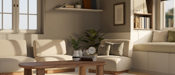 A cosy Scandinavian living room with comfortable chairs, a wooden coffee table, and decor.