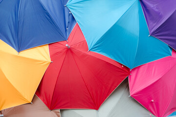Many colorful umbrellas stacked together create a work of art.