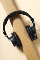 Over-ear, black headphones, on a dark background.