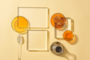 Glass platforms, petri dishes with honey on a minimalist background. Raw honey stimulates tissue...