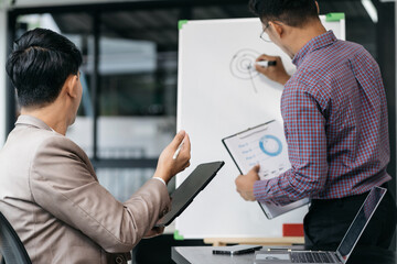 Business corporate team brainstorming, planning strategy having a discussion Analysis investment researching with chart at office desk documents in office.