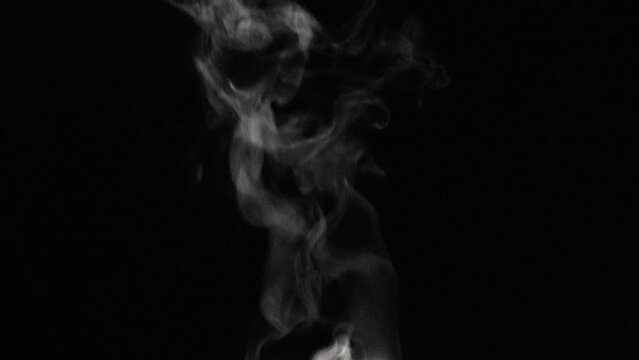 White natural rising steam  on black background. White Smoke Slowly Floating Rises Up.