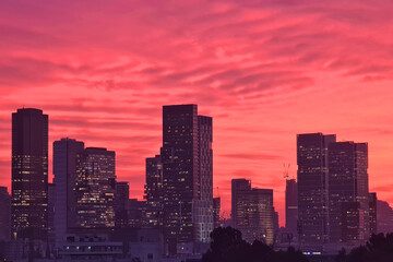Skyline of Tel Aviv city at sunset, Israel. Cityscape abstract pink background. Pink sky with clouds over the city, panoramic view. Sunset over Tel Aviv, Israel
