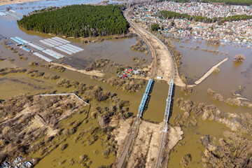 A high altitude view of the flooded countryside during spring floods. Railway with bridges over the...