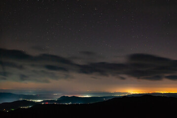 City lights seen from above. Light pollution covering the night sky. Amazing view with the...