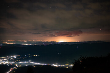City lights seen from above. Light pollution covering the night sky. Amazing view with the artificial lights observed from a high point