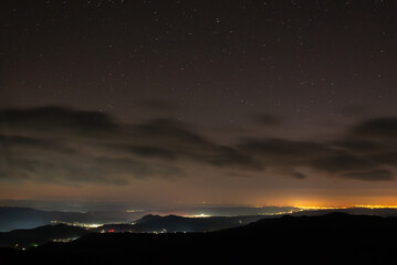City lights seen from above. Light pollution covering the night sky. Amazing view with the artificial lights observed from a high point