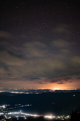 City lights seen from above. Light pollution covering the night sky. Amazing view with the artificial lights observed from a high point