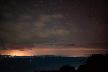 City lights seen from above. Light pollution covering the night sky. Amazing view with the artificial lights observed from a high point