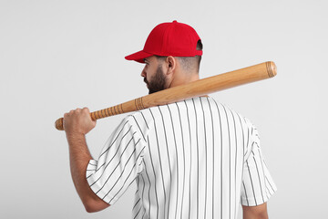 Man in stylish red baseball cap holding bat on white background, back view - Powered by Adobe