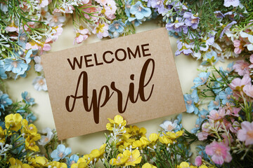 Welcome April text message with flower decoration on yellow background