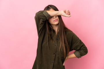 Young caucasian woman isolated on pink background covering eyes by hands
