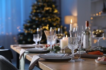 Christmas table setting with festive decor and dishware indoors